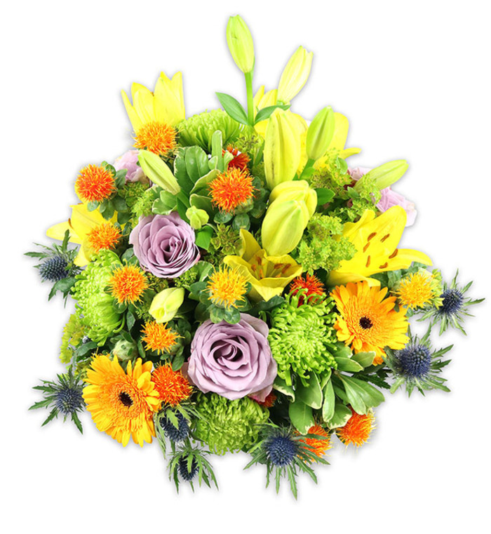 This densely packed, joyful bouquet is presented on a crisp white ground so every hue and texture can declare itself clearly: warm saffron yellows, pumpkin oranges, fresh chartreuse greens, soft lilac, and cool steel-blues combine in harmonious contrast. The arrangement is anchored by several yellow Asiatic lilies, some fully unfurled with delicate freckles and visible stamens, others standing tall as smooth buds, lending vertical rhythm and the suggestion of unfolding life. Two softly hued lavender roses sit near the heart of the design, their velvety spirals lending calm and traditional grace amidst the livelier flowers. Large orange Gerbera daisies fan their broad petals outward, their dark centres providing focal punctuation, while masses of lime-green button chrysanthemums create a ruffled, almost cushion-like body that enhances the bouquet's plushness. Sprays of small, round orange and golden accents - craspedia or similar spiky orbs - are scattered for playful texture, and several blue-grey Eryngium thistles project their starry, serrated bracts from lower flanks to introduce a cool, sculptural note. A selection of glossy and matte foliage - long lance leaves and smaller filler greens - unifies the composition and frames the blooms. The lighting is soft and diffuse, picking out satiny petal edges and gentle folds; you can almost sense the mixed perfume of lilies and roses. As a florist who often walks past Bunhill Fields and St Luke's Church, I picture this bouquet sitting in a bright flat near St Luke's Square or offered as a thoughtful centrepiece for celebrations and quiet remembrances in the local community.